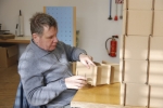 men sitting on chair will fowling boxes